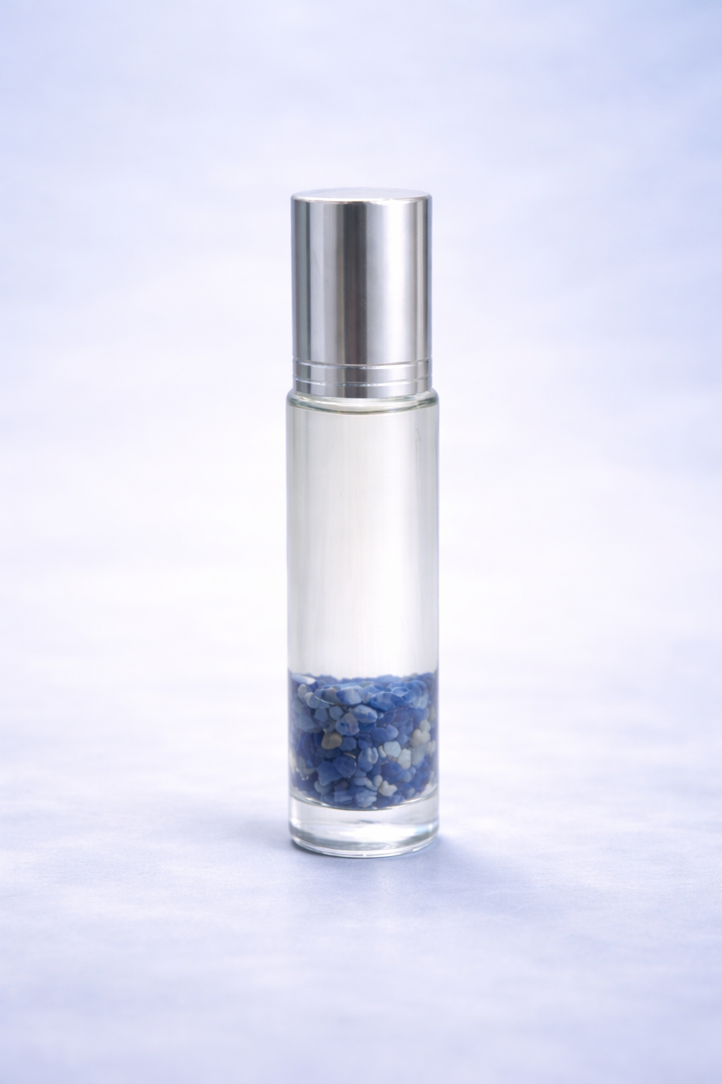 clear roller bottle infused with lapis lazuli representing the blend candor VIII which encouraging speaking your truth with out fear & with clear balanced assertiveness 
