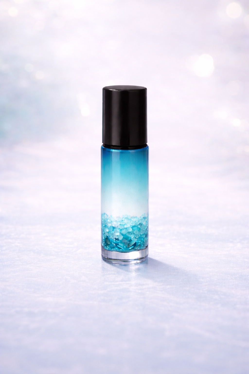 5ml blue gradient essential oil bottle with black cap representing the blend riddance infused with aquamarine crystals designed to support uneasy or unsettled stomach 
