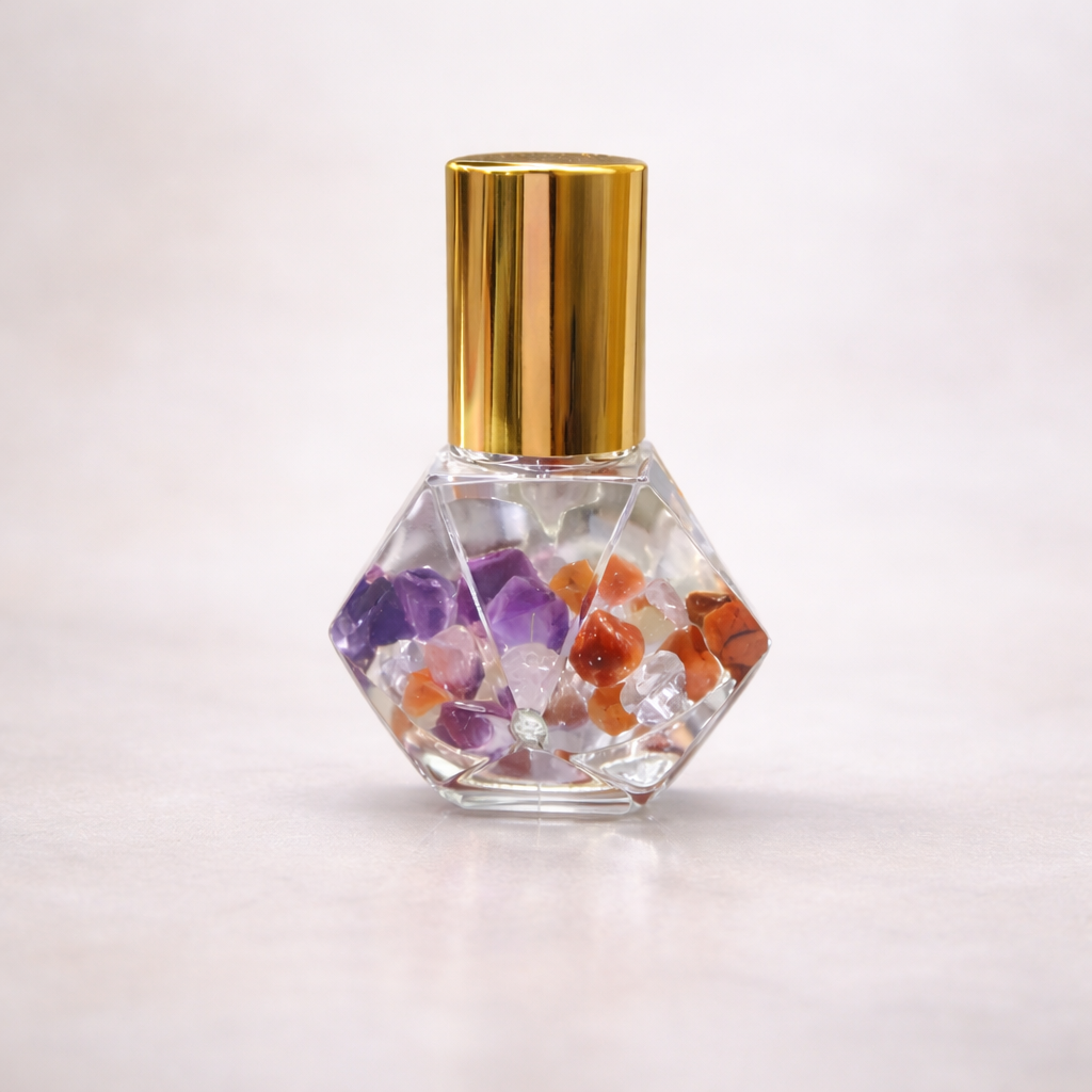 5ml clear diamond cut roller bottle with gold cap representing a blend that wncourages motivation & momentum infused with crystals amethyst, red agate & clear quartz 